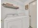 Laundry room featuring a white washer and dryer, wire shelving, and a white door with a gold handle at 13216 Parkhurst Ct, Riverview, FL 33569