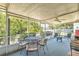 Inviting screened porch with comfortable seating, a ceiling fan, and views of the outdoor greenery and sunny yard at 13216 Parkhurst Ct, Riverview, FL 33569