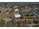 Aerial view showcases the community within its city surroundings and nearby water tanks at 1541 Heather Ridge Blvd # 1541, Dunedin, FL 34698