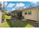 Lush backyard featuring a screened patio, green grass, and mature landscaping at 1541 Heather Ridge Blvd # 1541, Dunedin, FL 34698