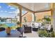 Spacious covered balcony featuring comfortable seating, a dining table, and a beautiful view of the lake and surrounding community at 18 Franklin S Ct # D, St Petersburg, FL 33711