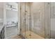Neutral bathroom with a large walk-in shower, granite counters, and connecting living area at 18 Franklin S Ct # D, St Petersburg, FL 33711
