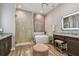 A luxurious bathroom features a soaking tub, glass shower, and vanity with decorative lighting at 18 Franklin S Ct # D, St Petersburg, FL 33711