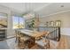 Elegant dining room featuring a rustic wood table, stylish chairs, a modern chandelier, and plenty of natural light at 18 Franklin S Ct # D, St Petersburg, FL 33711
