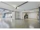 Spacious three-car garage with epoxy floors, ample lighting, and storage space at 18 Franklin S Ct # D, St Petersburg, FL 33711