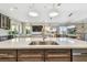A chef's kitchen provides a large island with stainless sink and open view into the living and dining areas at 18 Franklin S Ct # D, St Petersburg, FL 33711