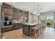 Modern kitchen with a large center island, barstool seating, stainless steel appliances, and stylish cabinetry at 18 Franklin S Ct # D, St Petersburg, FL 33711