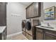 Efficient laundry room equipped with new appliances, ample cabinet space, and countertop at 18 Franklin S Ct # D, St Petersburg, FL 33711