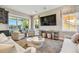 Bright and airy living room featuring comfortable seating, a large TV, and a scenic view of the outdoors at 18 Franklin S Ct # D, St Petersburg, FL 33711