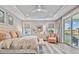 Serene main bedroom with a tray ceiling, neutral tones, a sitting area, and access to a private balcony at 18 Franklin S Ct # D, St Petersburg, FL 33711