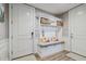 Convenient mudroom with built-in bench, storage cabinets, and stylish decor at 18 Franklin S Ct # D, St Petersburg, FL 33711