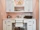 Built-in desk with white cabinets, shelves, drawers, and overhead lighting create a dedicated workspace at 18 Franklin S Ct # D, St Petersburg, FL 33711