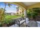 Relaxing covered patio overlooking lush landscaping and a serene pond at 18 Franklin S Ct # D, St Petersburg, FL 33711