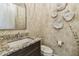 Elegant powder room with patterned wallpaper, stylish fixtures, and a decorative mirror at 18 Franklin S Ct # D, St Petersburg, FL 33711