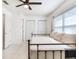 Bright bedroom with tile floors, ceiling fan, natural light, and closet space at 521 Pinellas Bayway S # 204, St Petersburg, FL 33715