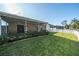The manicured back yard includes a partial fence and covered patio at 5913 Lawrin Ct, Wesley Chapel, FL 33544