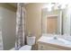 Bathroom with a tub, toilet, and sink with a large mirror at 5913 Lawrin Ct, Wesley Chapel, FL 33544