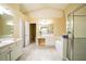 Bright primary bathroom featuring double vanity, soaking tub, walk-in shower and tile floors at 5913 Lawrin Ct, Wesley Chapel, FL 33544