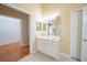 Bathroom with single sink vanity, tile floors, and walk-in shower and access to a walk-in closet at 5913 Lawrin Ct, Wesley Chapel, FL 33544