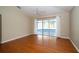 Spacious bedroom with hardwood floors, ceiling fan, and sliding glass doors to screened patio at 5913 Lawrin Ct, Wesley Chapel, FL 33544