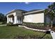 Exterior shot of the fitness center with white columns, lush landscaping, and a well-maintained lawn at 5913 Lawrin Ct, Wesley Chapel, FL 33544