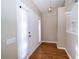 Bright foyer featuring wood floors, elegant light fixture, and a view into the home at 5913 Lawrin Ct, Wesley Chapel, FL 33544