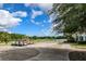 Golf carts parked near a golf course with a lake view under a sunny sky at 5913 Lawrin Ct, Wesley Chapel, FL 33544
