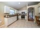 Well-equipped kitchen featuring stainless steel appliances, granite countertops, and white cabinetry at 5913 Lawrin Ct, Wesley Chapel, FL 33544