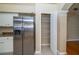 Kitchen featuring stainless steel refrigerator, white cabinets and granite countertops, plus a pantry at 5913 Lawrin Ct, Wesley Chapel, FL 33544