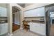 Functional kitchen nook with white cabinets, granite countertops, and a built-in desk area at 5913 Lawrin Ct, Wesley Chapel, FL 33544