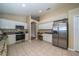 Bright kitchen featuring white cabinets, stainless steel appliances, granite countertops and tile floors at 5913 Lawrin Ct, Wesley Chapel, FL 33544