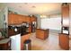 An open kitchen offers stainless appliances and a black breakfast bar at 5913 Lawrin Ct, Wesley Chapel, FL 33544