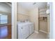 A full size washer and dryer are complimented by shelf space at 5913 Lawrin Ct, Wesley Chapel, FL 33544