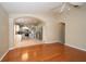 Open floor plan showcasing hardwood floors and arches into the kitchen and other living spaces at 5913 Lawrin Ct, Wesley Chapel, FL 33544