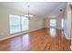 Spacious living room with gleaming laminate floors and plenty of natural light from large windows at 5913 Lawrin Ct, Wesley Chapel, FL 33544