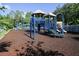 A colorful playground featuring slides and climbing structures on a wood chip ground at 5913 Lawrin Ct, Wesley Chapel, FL 33544