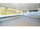 A large screened in patio with tile floor and ceiling fans at 5913 Lawrin Ct, Wesley Chapel, FL 33544