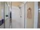 Close-up view of the glass enclosed shower with upgraded shower head at 5913 Lawrin Ct, Wesley Chapel, FL 33544