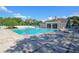 Large swimming pool with clear blue water, surrounded by a brick patio, and comfortable lounge chairs at 5913 Lawrin Ct, Wesley Chapel, FL 33544