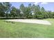 Outdoor sand volleyball court with benches and grass surroundings, great for recreation at 5913 Lawrin Ct, Wesley Chapel, FL 33544