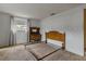 Bedroom with neutral carpet, side table, and bright window with curtain at 6636 Carnation Way, Port Richey, FL 34668