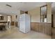 Bright and airy kitchen area with wooden paneling and an ample layout at 6636 Carnation Way, Port Richey, FL 34668