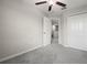 Neutral colored bedroom features carpet, a ceiling fan, and a closet at 9716 Mulberry Marsh Ln, Sun City Center, FL 33573