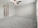 Spacious bedroom with ceiling fan, carpet, and natural light from window at 9716 Mulberry Marsh Ln, Sun City Center, FL 33573