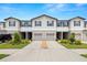 Charming townhome showcasing a two-story facade, driveway and a well-manicured front lawn at 9716 Mulberry Marsh Ln, Sun City Center, FL 33573