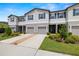 This two-story townhome features blue shutters, a driveway and tidy front yard at 9716 Mulberry Marsh Ln, Sun City Center, FL 33573