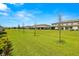 Manicured lawn in front of the townhomes provides residents with plenty of room to enjoy the outdoors at 9716 Mulberry Marsh Ln, Sun City Center, FL 33573