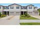 Inviting townhome with a well-kept lawn, two-car garage, and convenient driveway at 9716 Mulberry Marsh Ln, Sun City Center, FL 33573