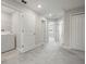 Hallway with laundry room access and views into bedrooms with carpet at 9716 Mulberry Marsh Ln, Sun City Center, FL 33573