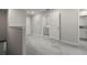 Hallway features neutral colored carpet and a laundry room with washer and dryer at 9716 Mulberry Marsh Ln, Sun City Center, FL 33573